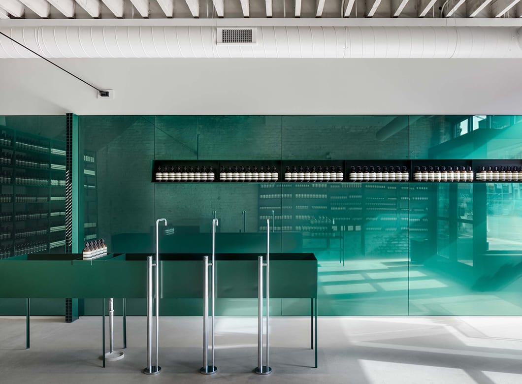 A wide view of the custom glass wall cladding by Archetype Glass at Aesop West Loop