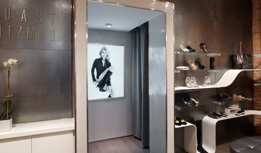 A wide view of the custom art glass wall cladding at Stuart Weitzman Soho, crafted by Archetype Glass
