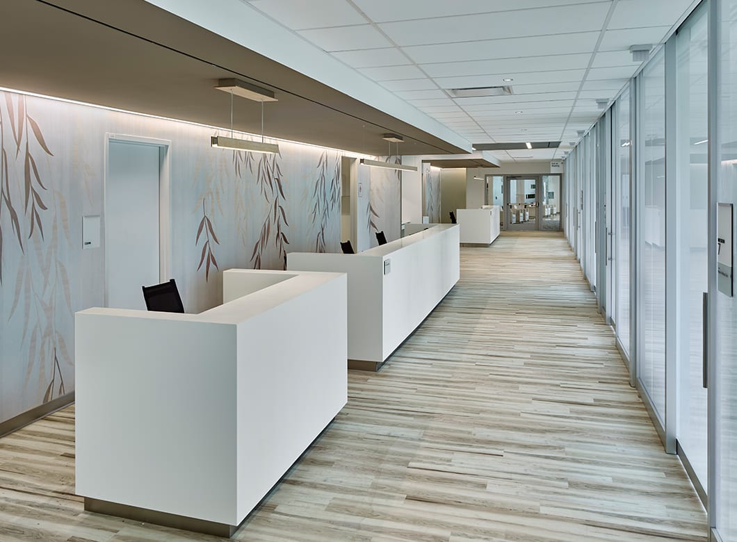 A view of the Asplundh Cancer Pavilion's reception hall featuring Archetype Glass' custom glass partition walls and custom glass doors