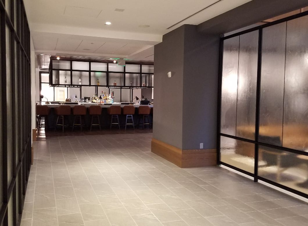 A view of the hallway of the Verizon Basking Ridge Hotel, featuring Archetype Glass' custom frosted glass partition walls