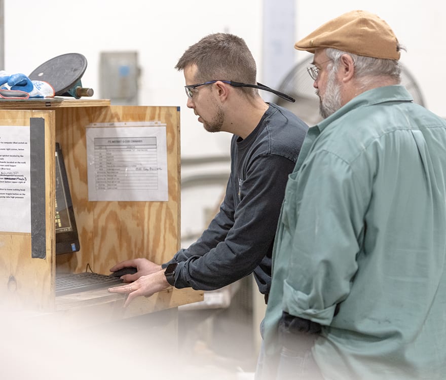 Two team members at Archetype Glass customizing laminated decorative glass for interior designers