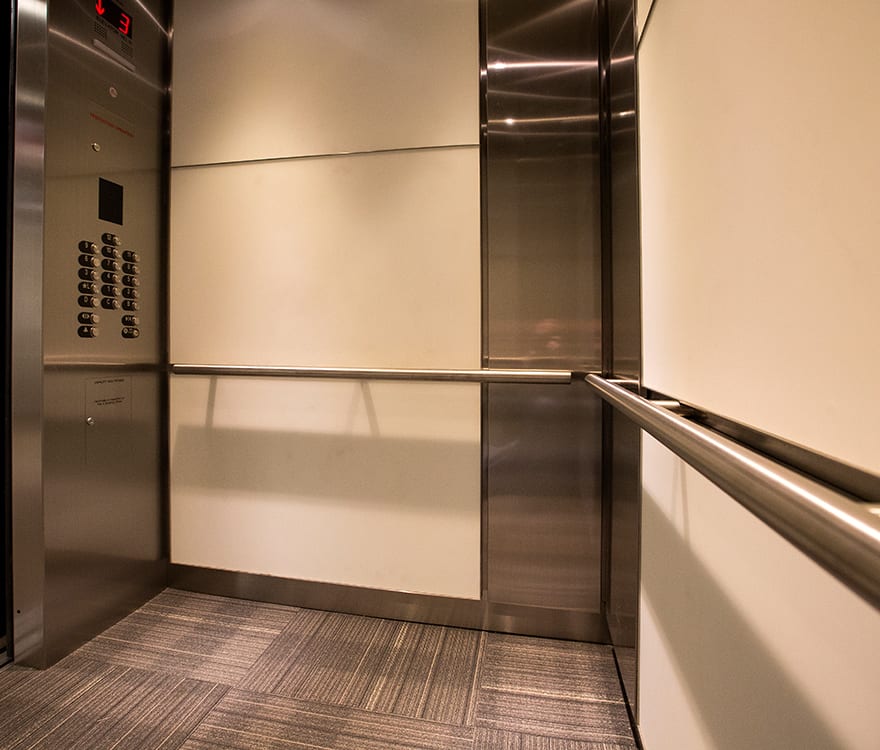 A view of the custom glass elevator cabs in the 6402 Arlington Boulevard elevator