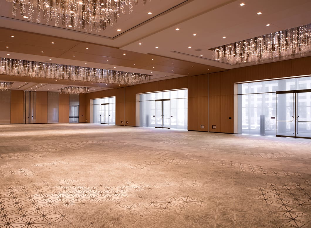 A view of the empty ballroom at the Conrad Washington Hotel, featuring the space's custom laminated glass partition walls, crafted by Archetype Glass