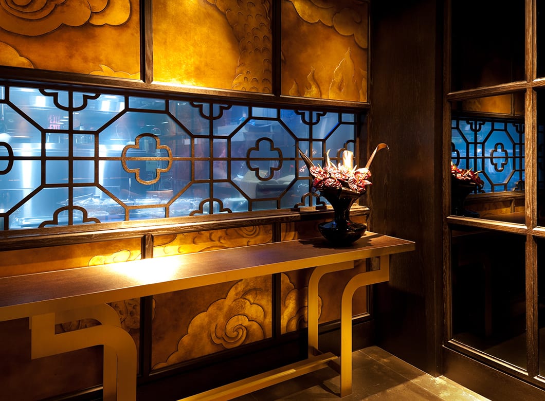 Translucent custom glass wall cladding and custom mirrors in the hallway at Hakkasan Restaurant, by Archetype Glass