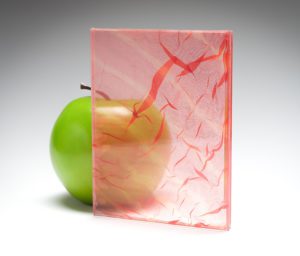 A red transparent sample of the new custom fabric glass in coordination with Spatial Element.