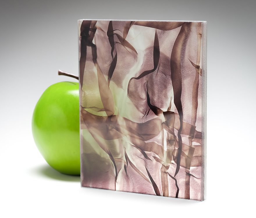 A wine-colored sample of the new barely transparent custom fabric glass in coordination with Spatial Element.