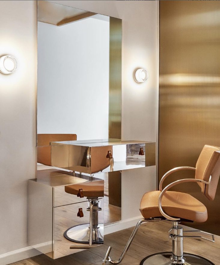 A detailed view of the custom laminated tinted ribbed mirrored glass created by Archetype Glass for the Jenna Perry Hair Salon in New York