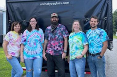 The team at Archetype Glass, experts in custom laminated glass, celebrating their Tie Dye Team Picnic,