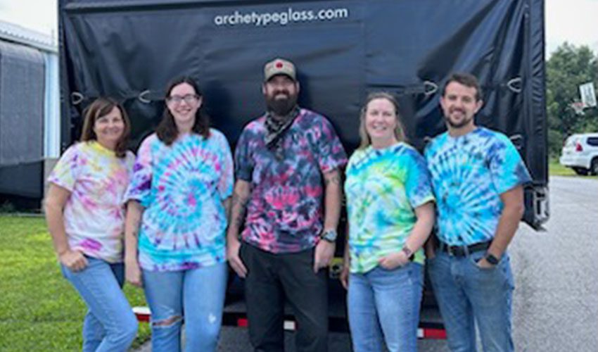 The team at Archetype Glass, experts in custom laminated glass, celebrating their Tie Dye Team Picnic,